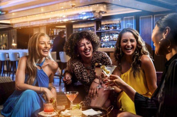 4 women enjoying beverage in a cruise lounge